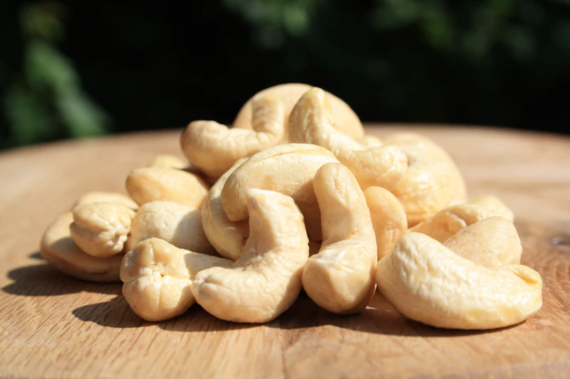 Pile of cashew nuts on a wooden table