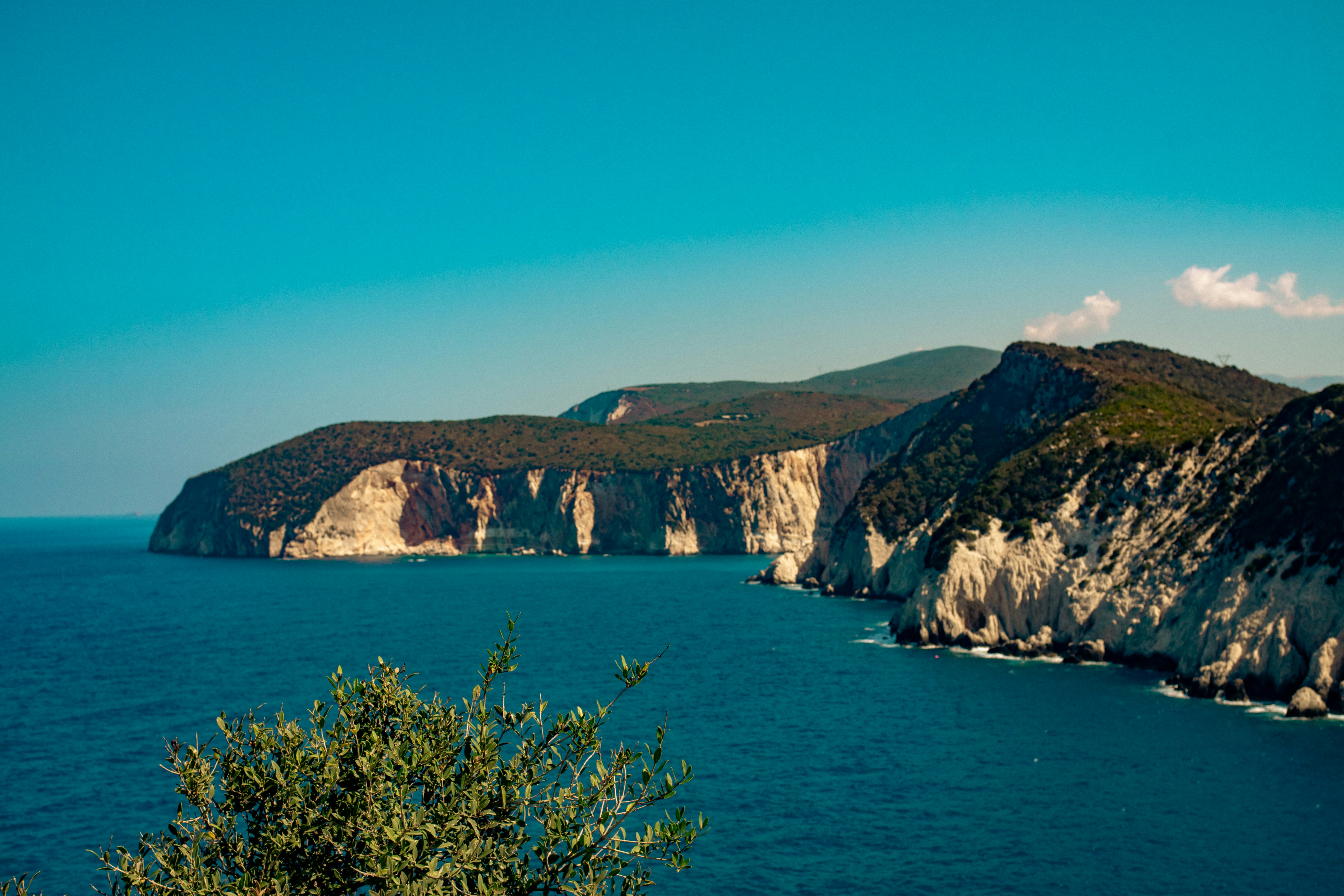 A large body of water surrounded by mountains, 