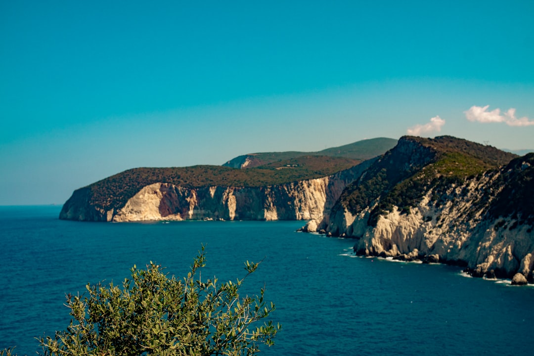 A large body of water surrounded by mountains,