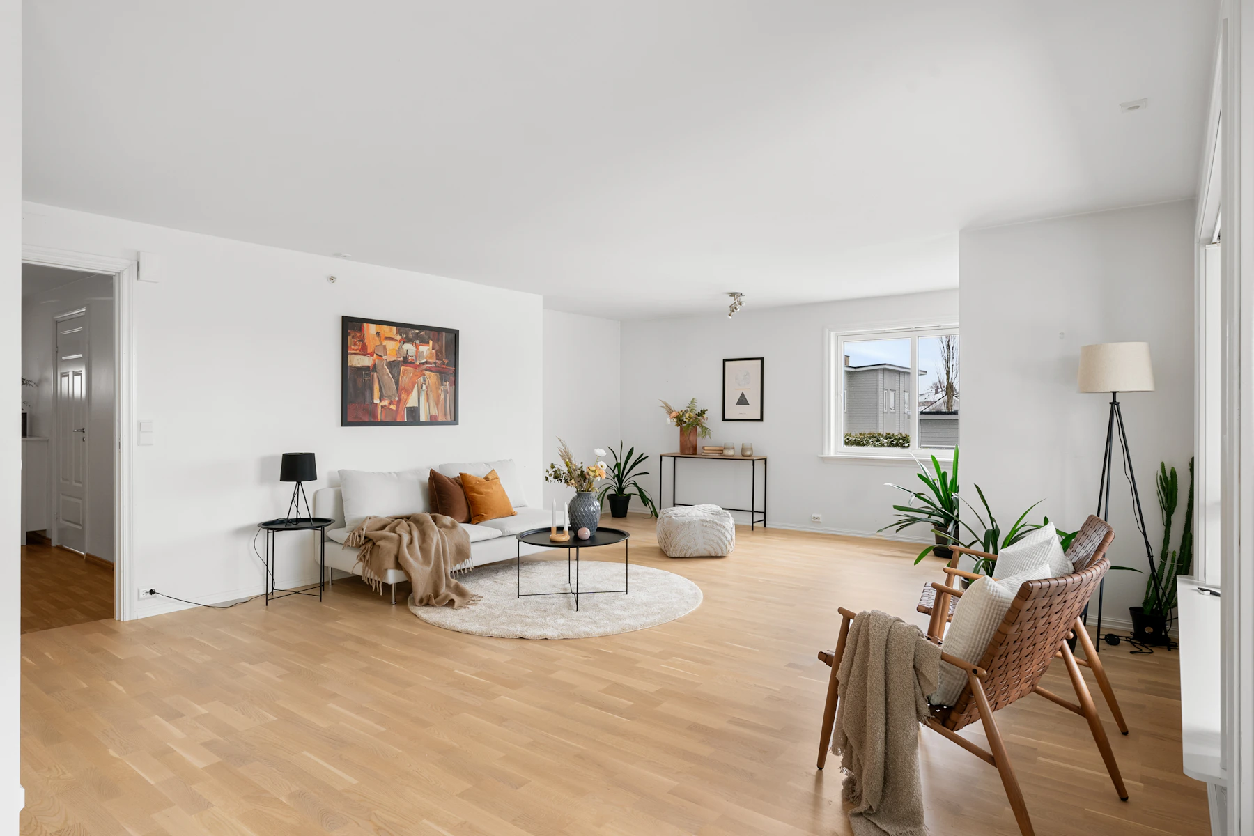Natural wood flooring in a bright living room with neutral furnishings