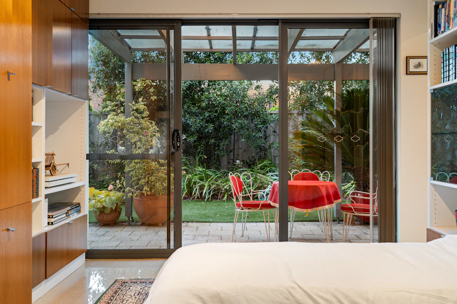 Bedroom with full-height sliding glass door system after track and roller service