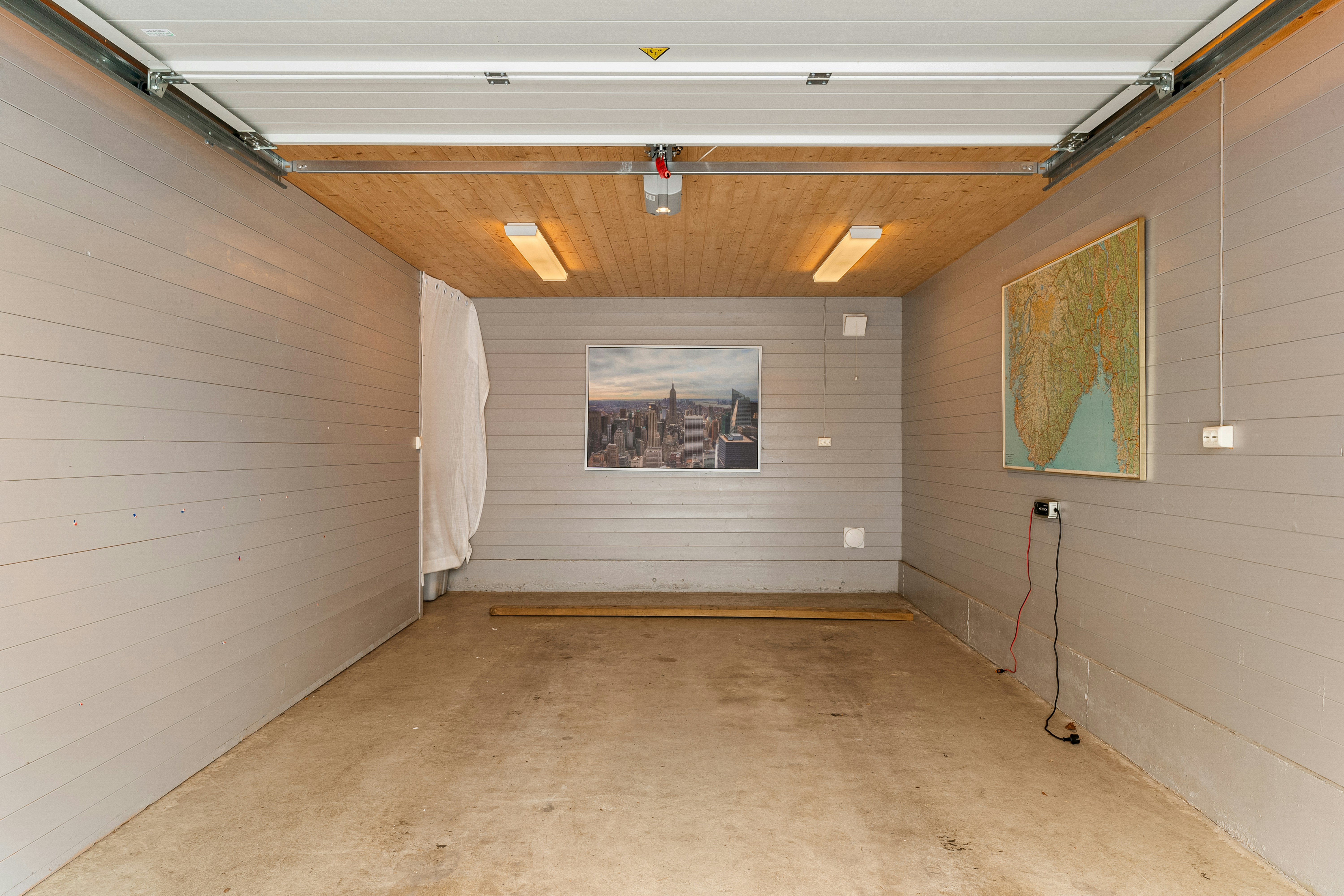 Wall‑mounted Level 2 EV charger in a home garage