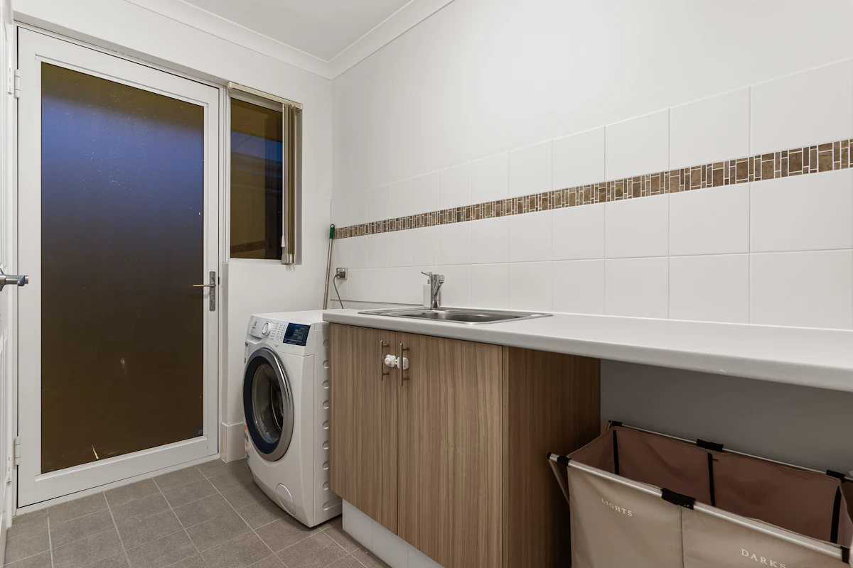 Washer and dryer built into a custom laundry cabinet