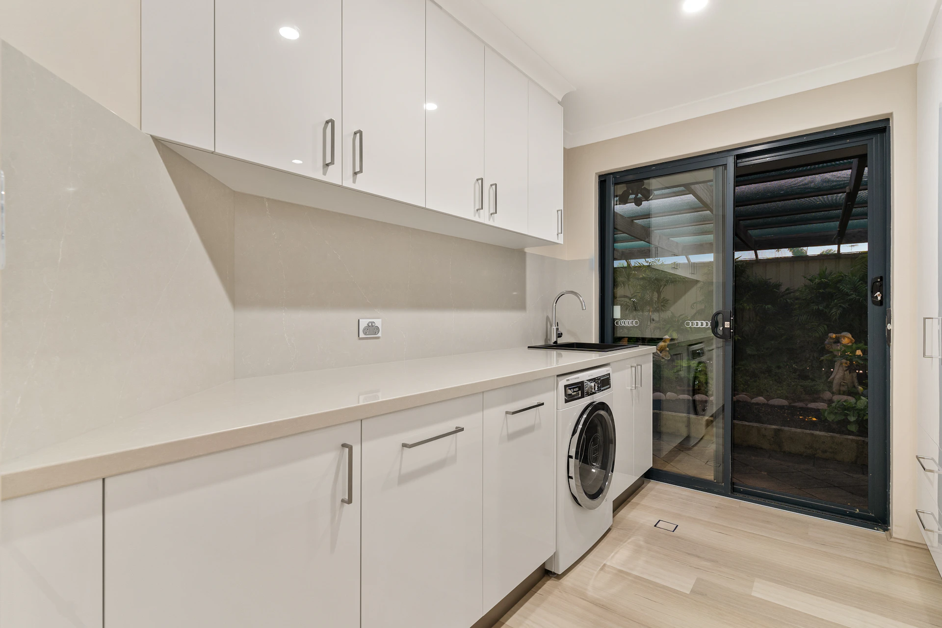 A kitchen with a washer and dryer in it