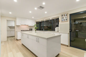 A large kitchen with a center island in the middle of the room