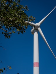 A wind turbine with a blue sky in the background