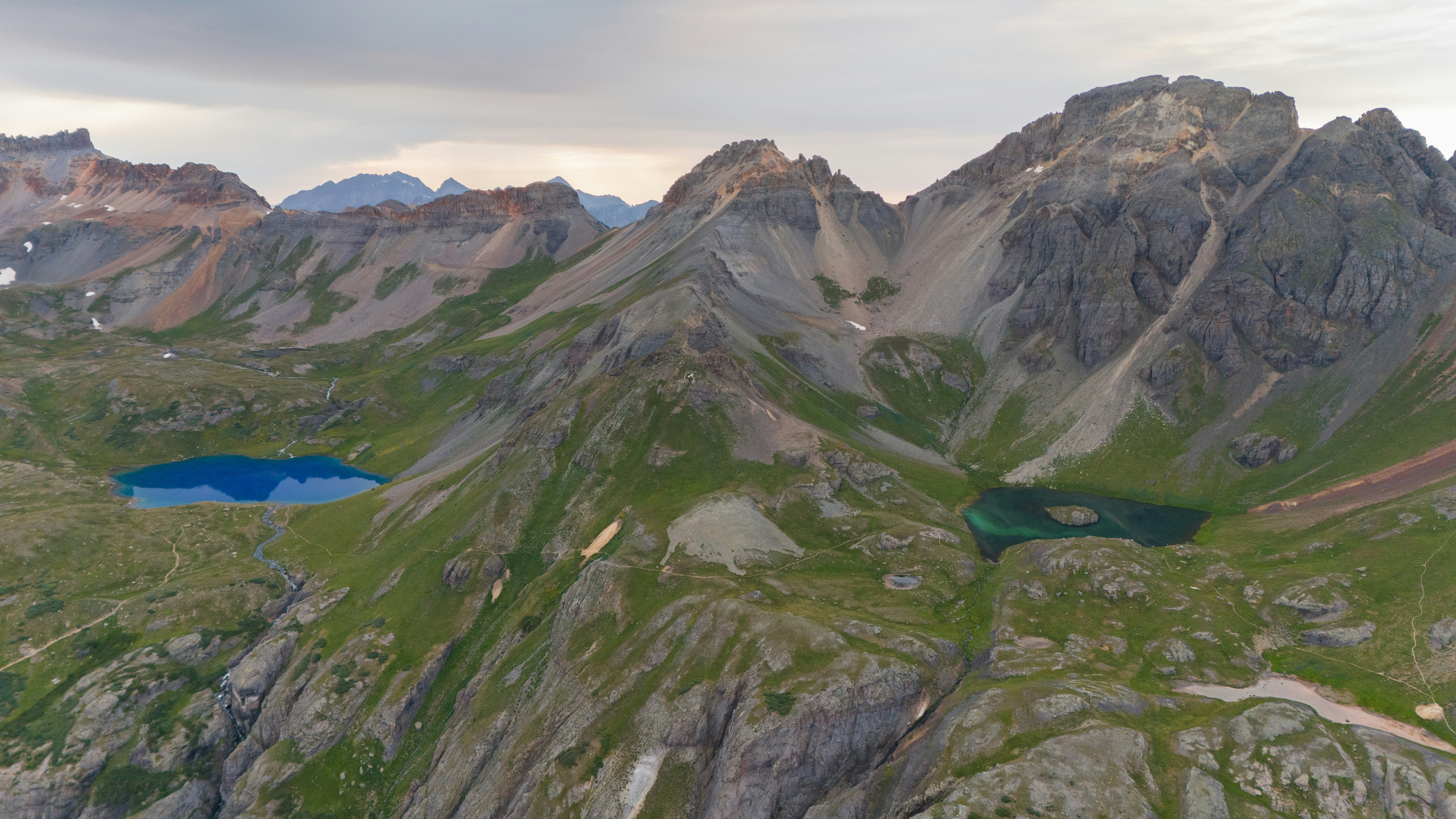 An aerial view of a mountain range with a lake in the middle