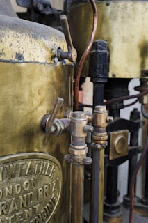 A close up of a metal tank with a hose connected to it