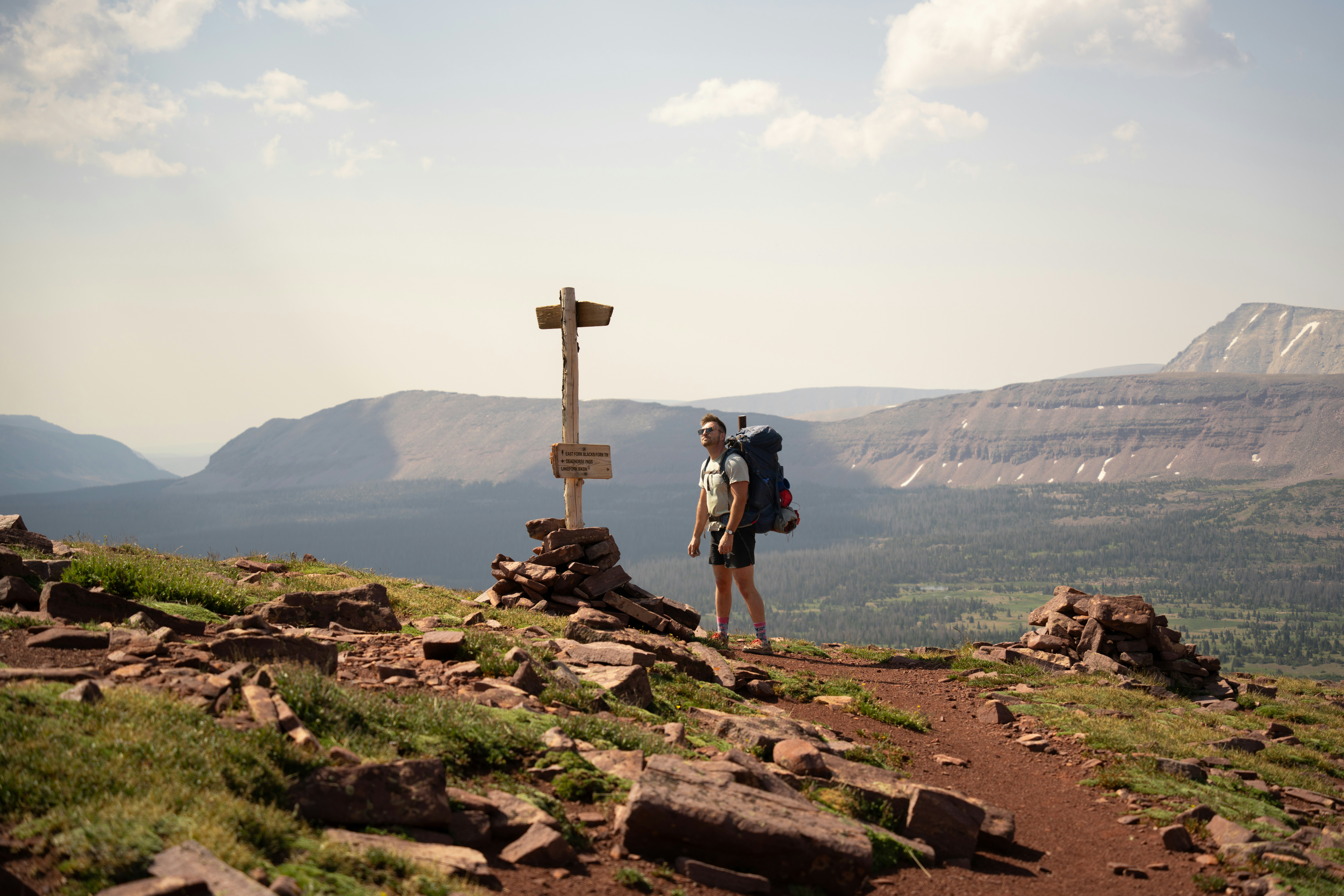 A couple of people standing on a hill