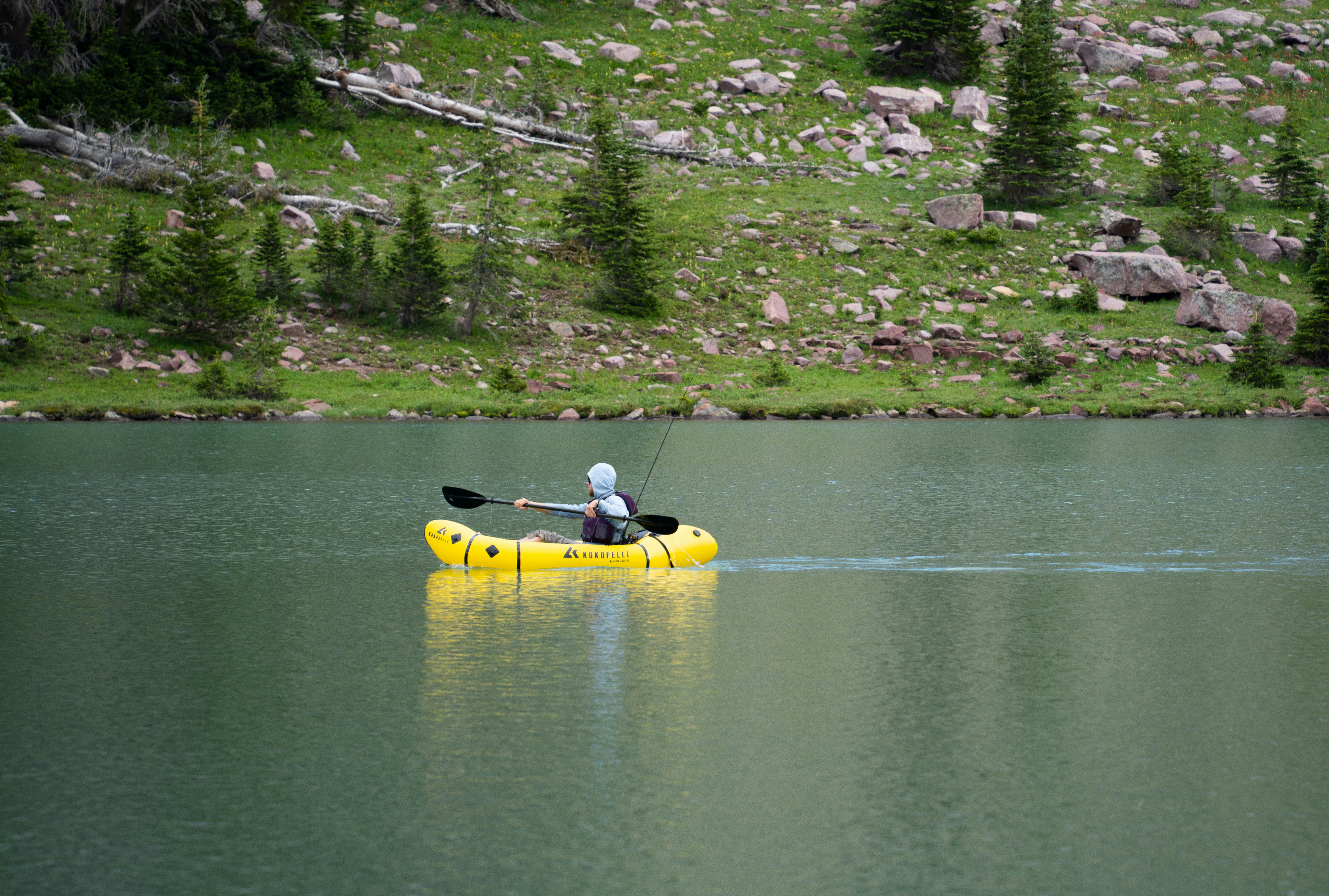 A person in a yellow kayak on a lake