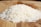 A pile of rice sitting on top of a wooden cutting board