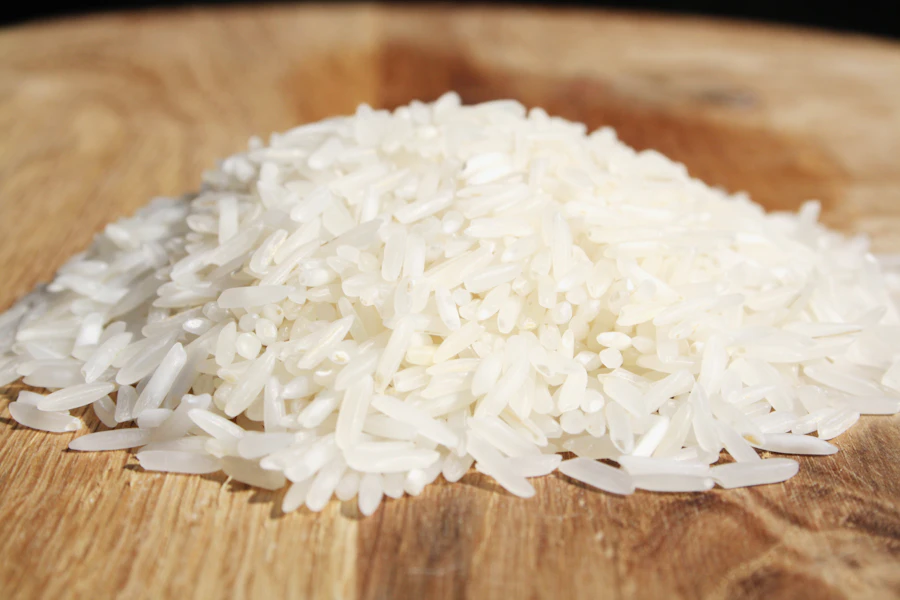 Grains of white rice on a wooden board