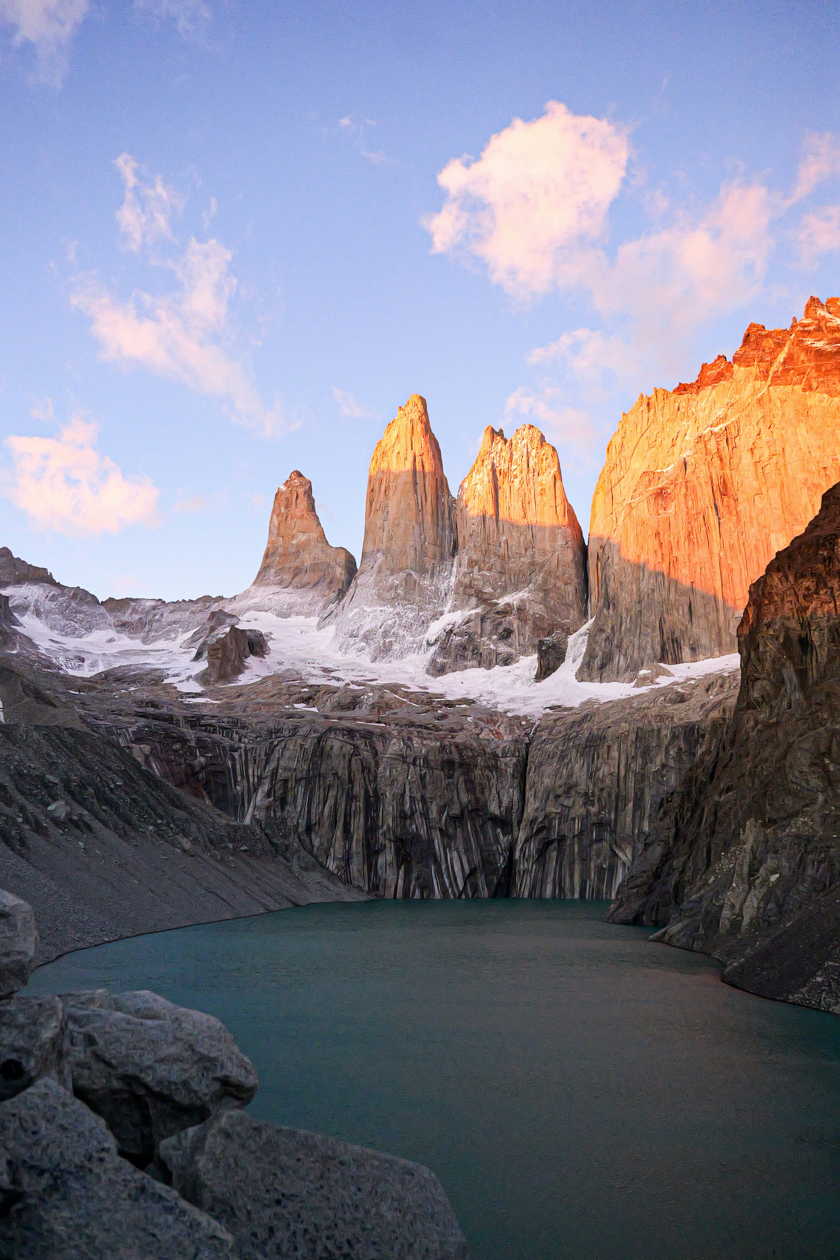 A mountain range with a lake in the foreground