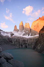 A mountain range with a lake in the foreground
