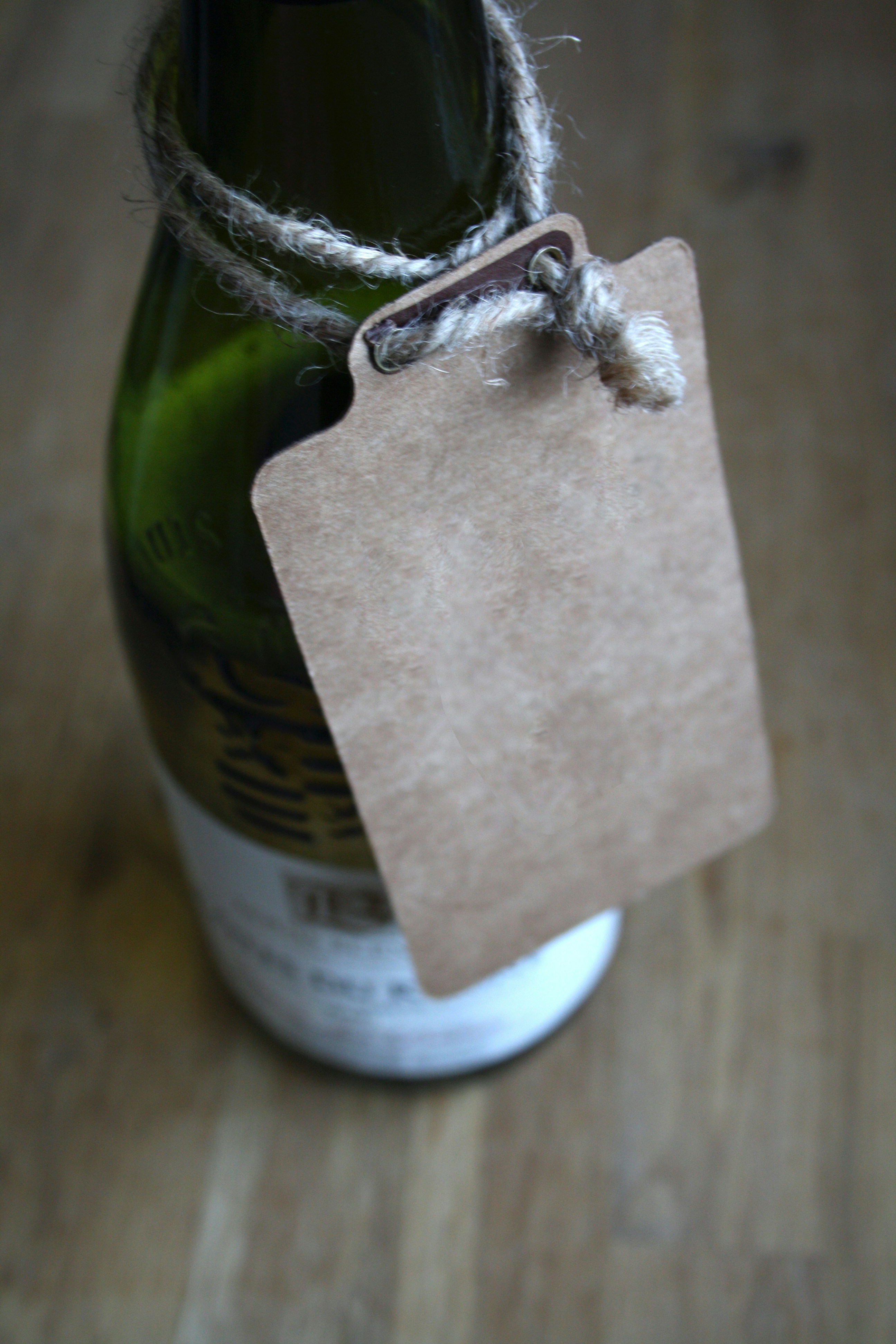 A bottle of beer with a tag attached to it