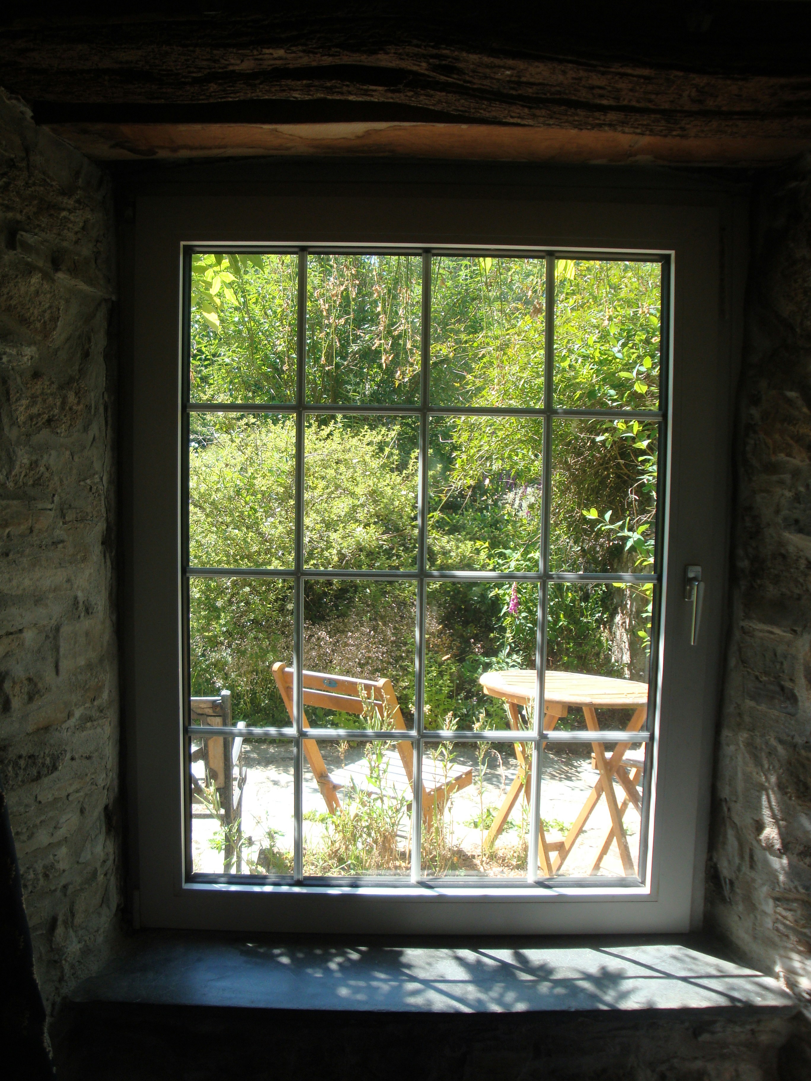 A window with a view of a table and chairs