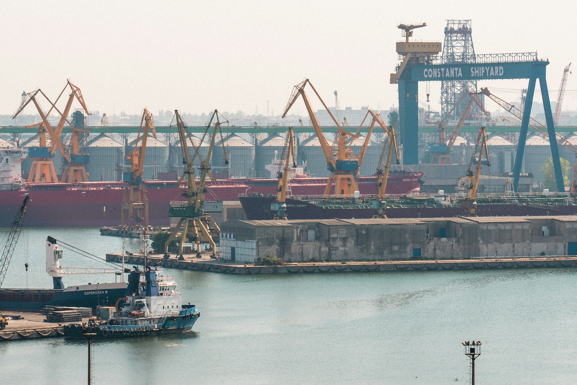 A harbor filled with lots of boats and cranes