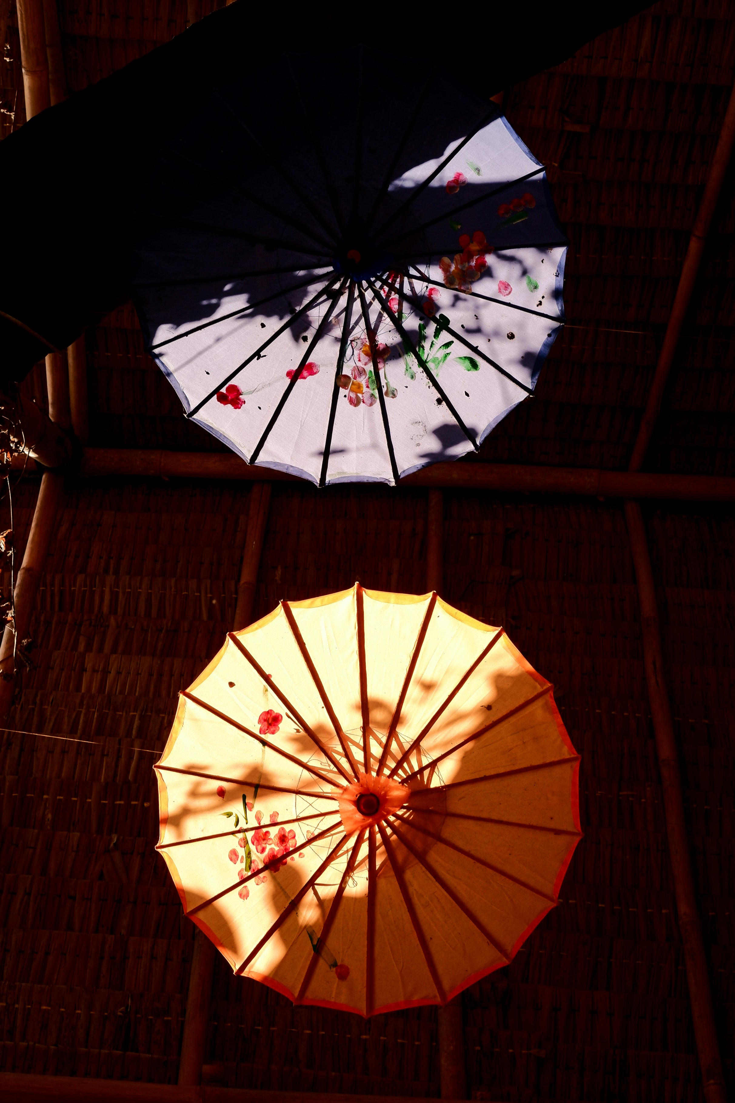 A couple of umbrellas that are hanging from a ceiling