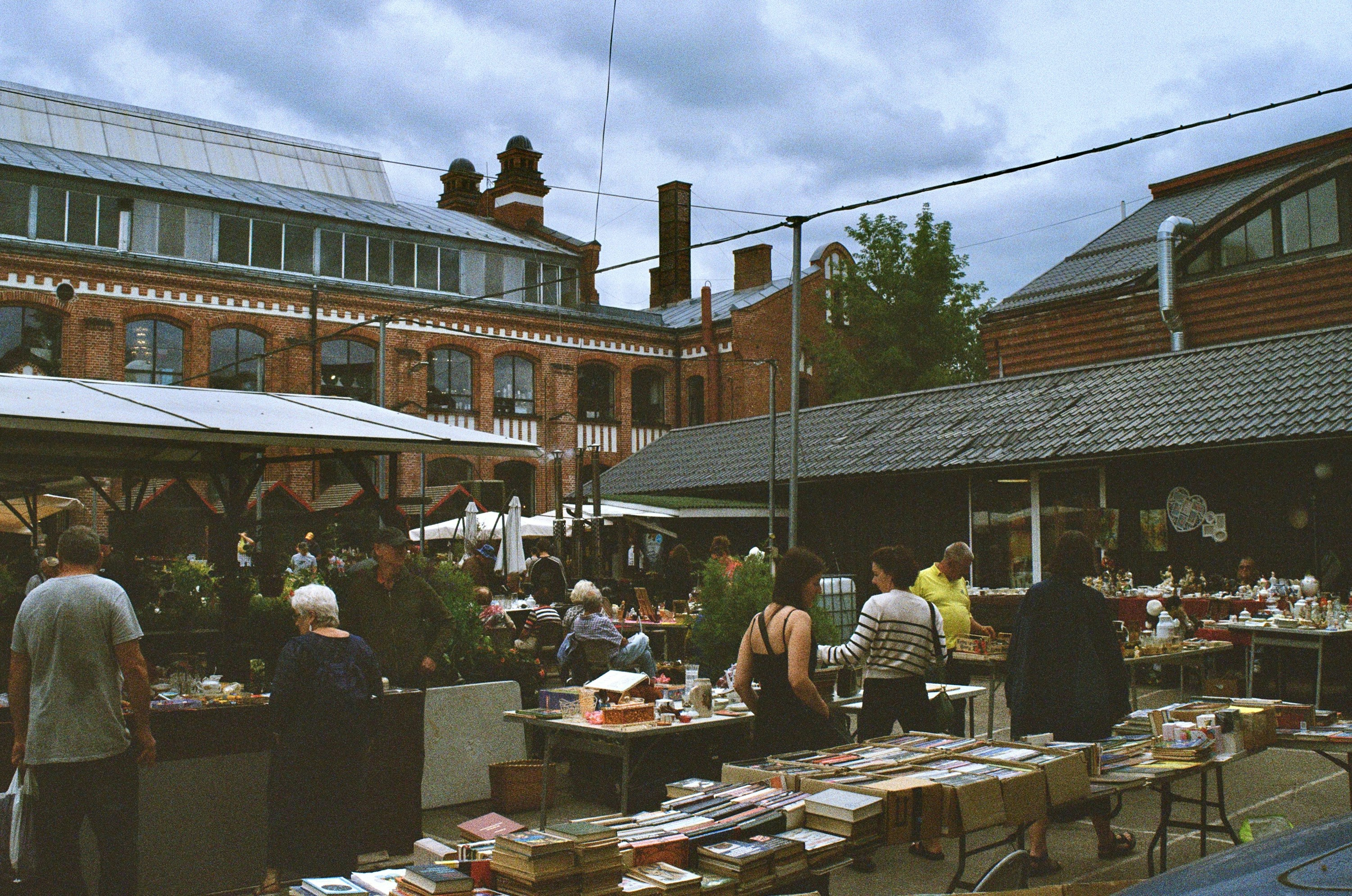 A group of people standing around a table filled with books