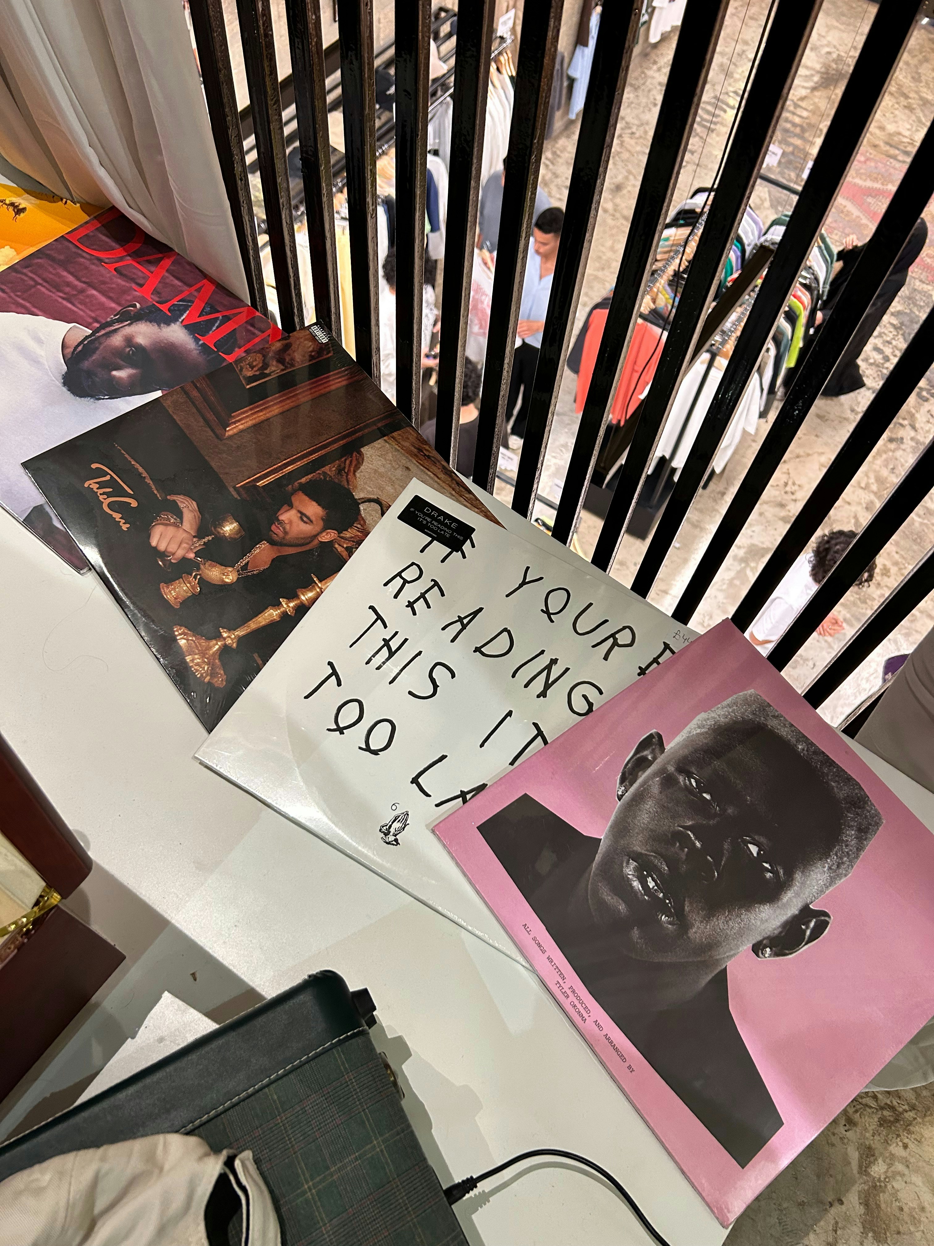 Vinyl records and music equipment arranged aesthetically on a white surface