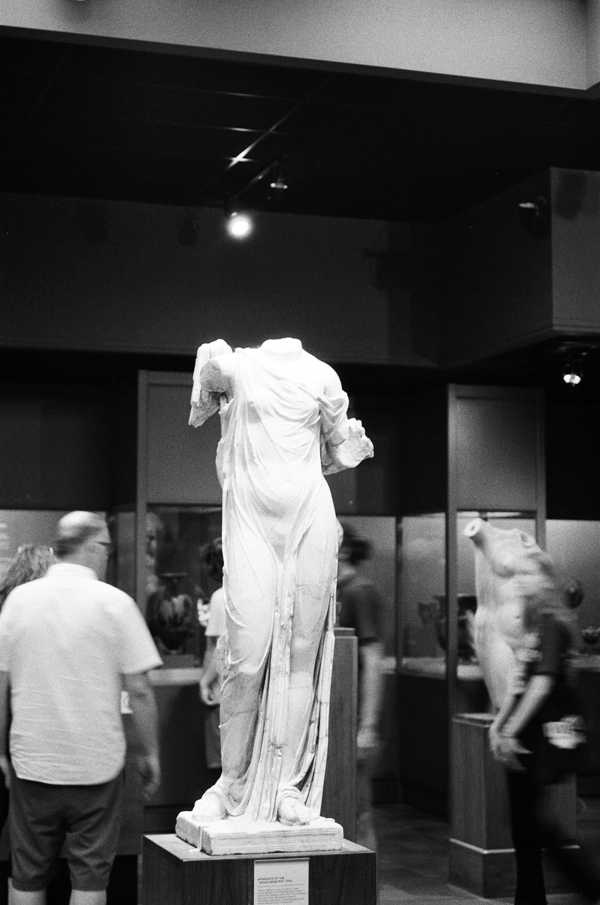 A group of people standing around a statue