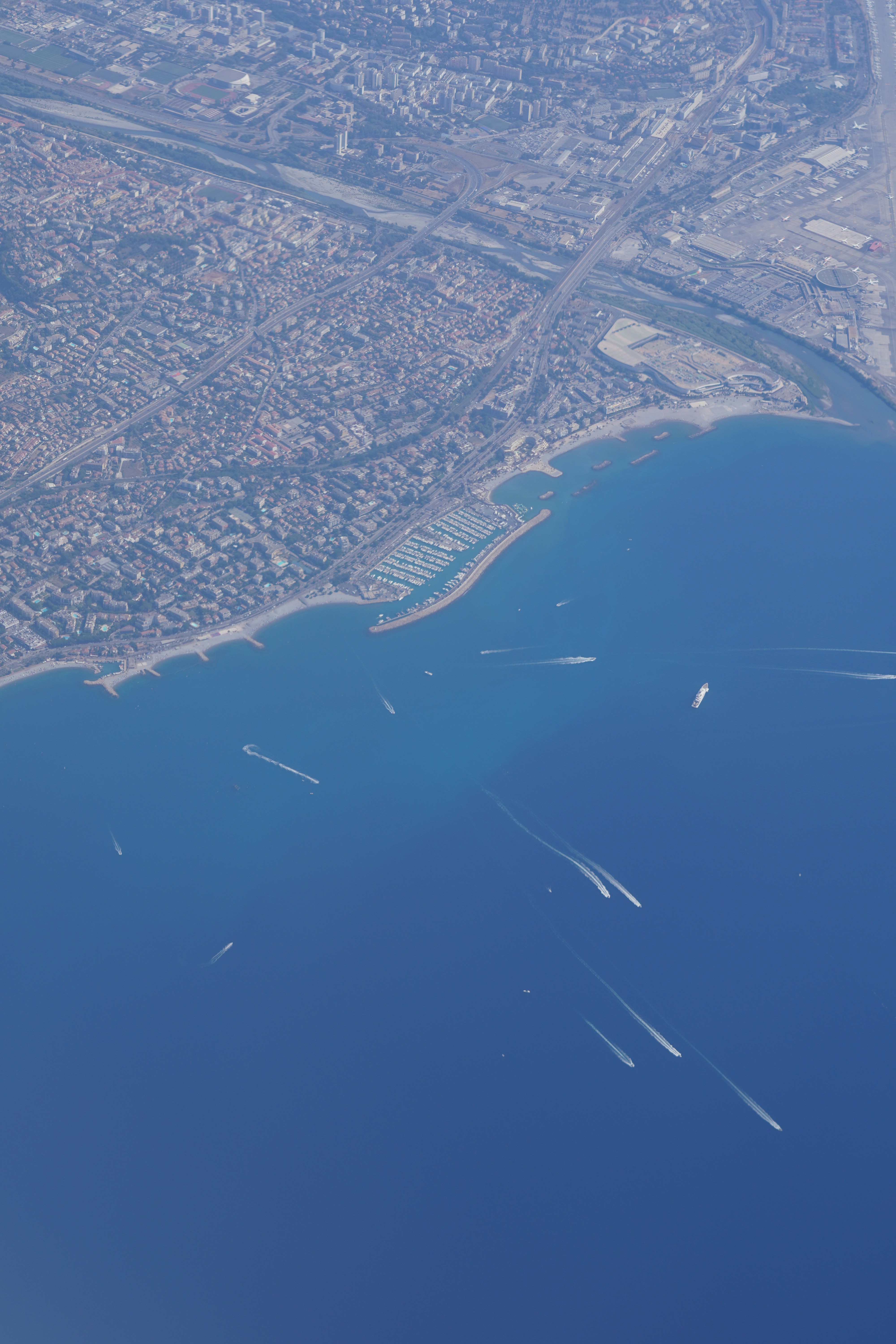 View from under a parachute canopy, looking down at the coastline.