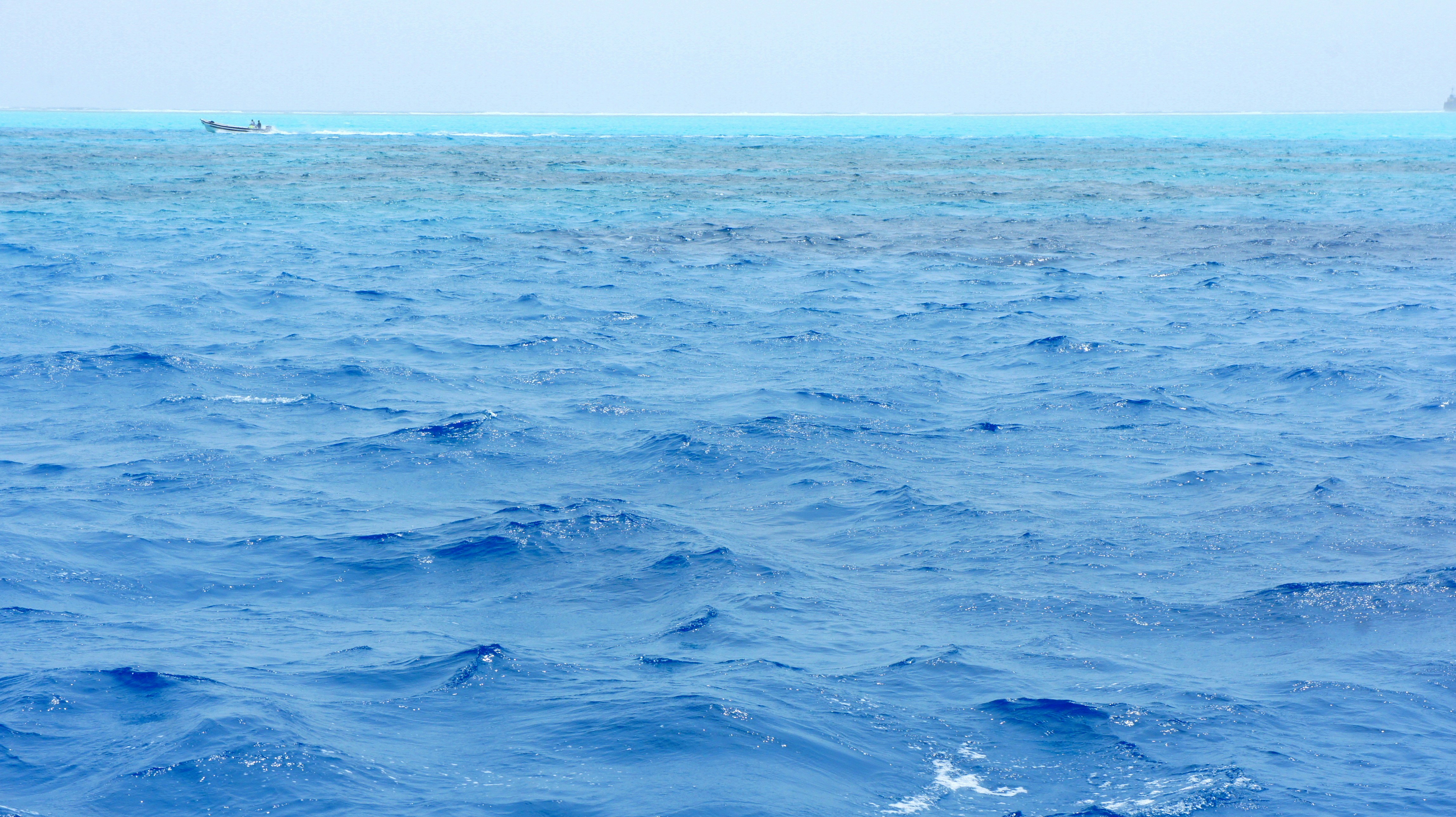 A large body of water with a boat in the distance