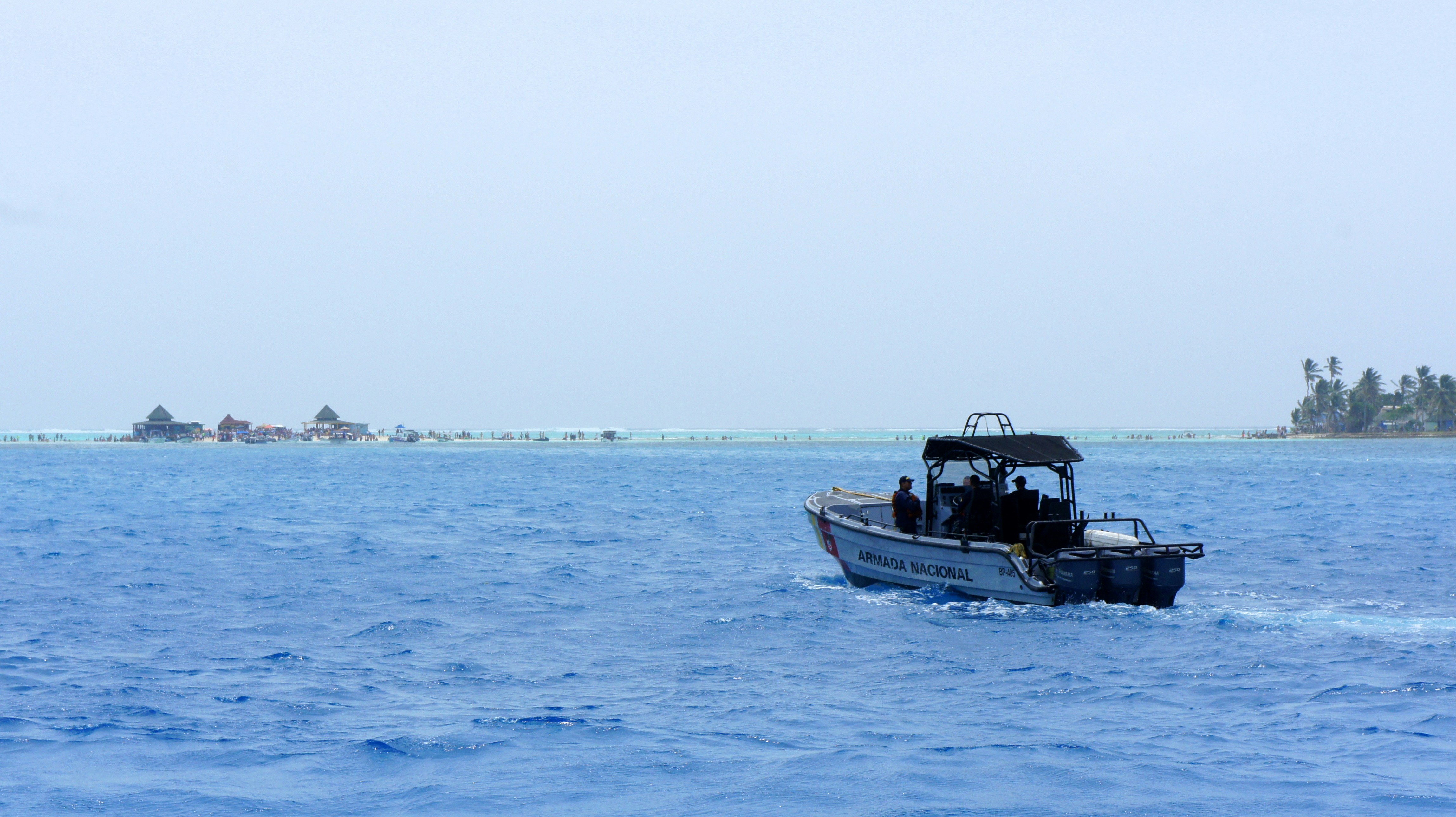 A small boat in the middle of a large body of water