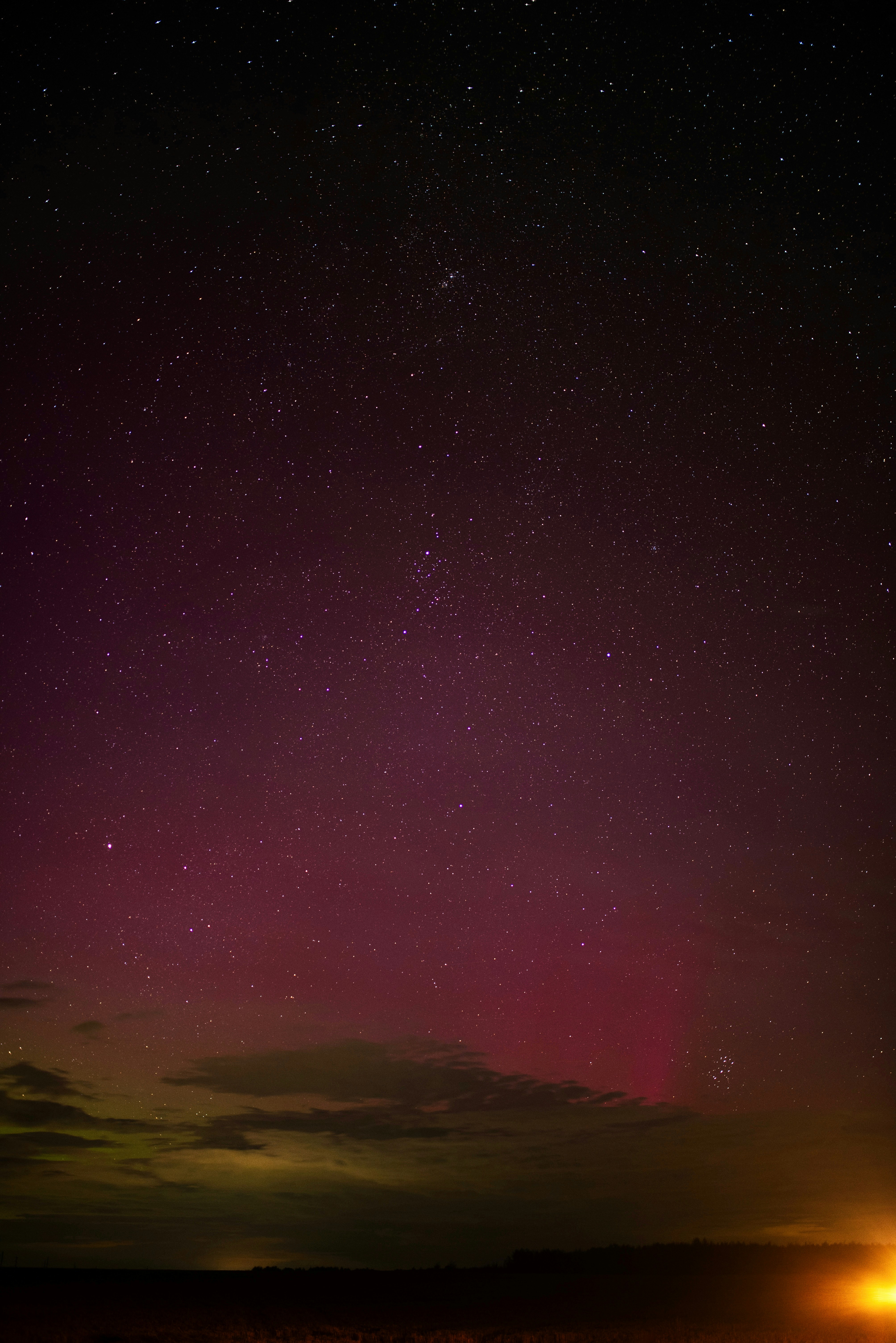The night sky with stars above a field