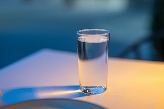 A glass of water sitting on top of a table