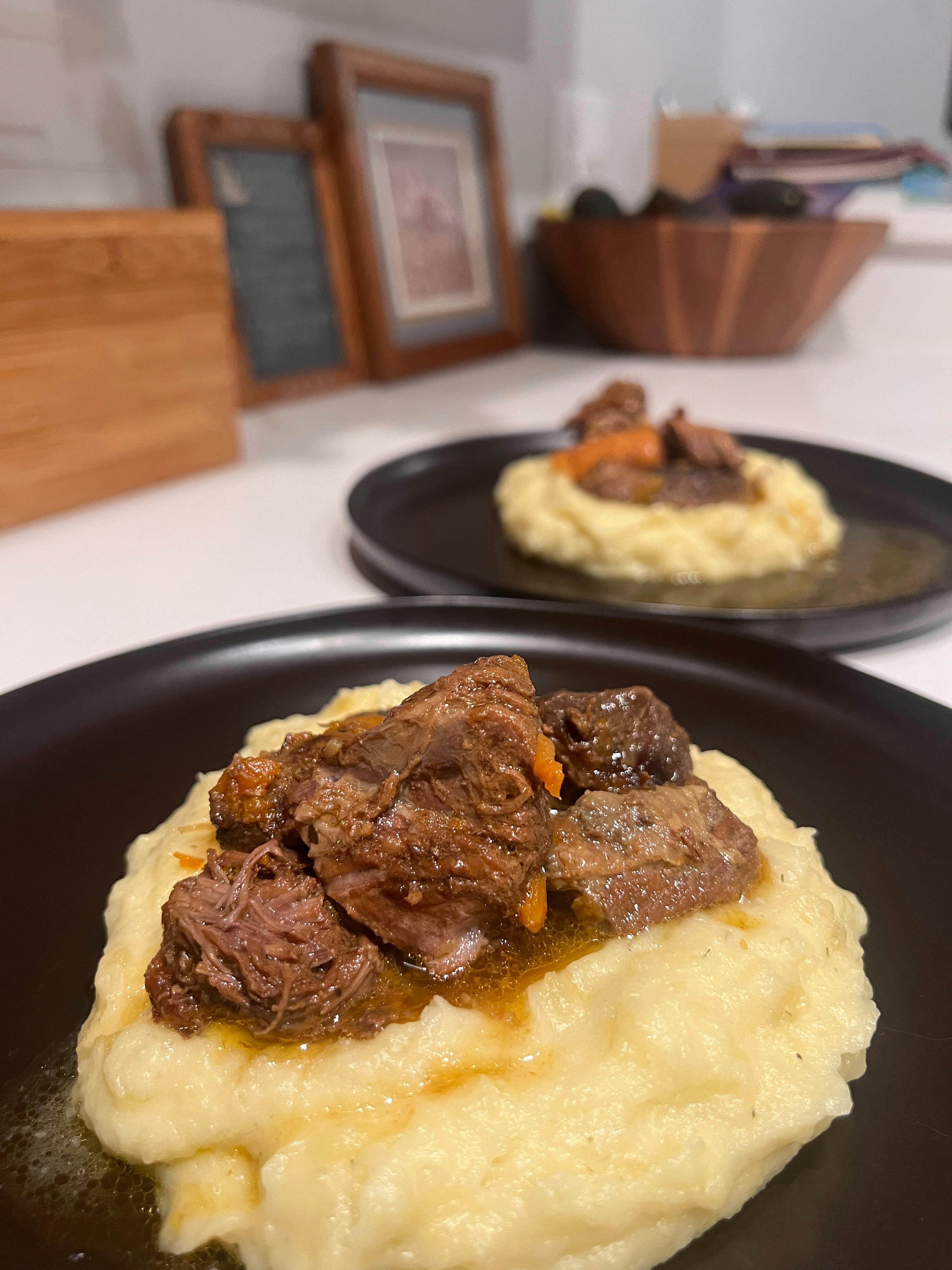 A plate of mashed potatoes with beef and gravy