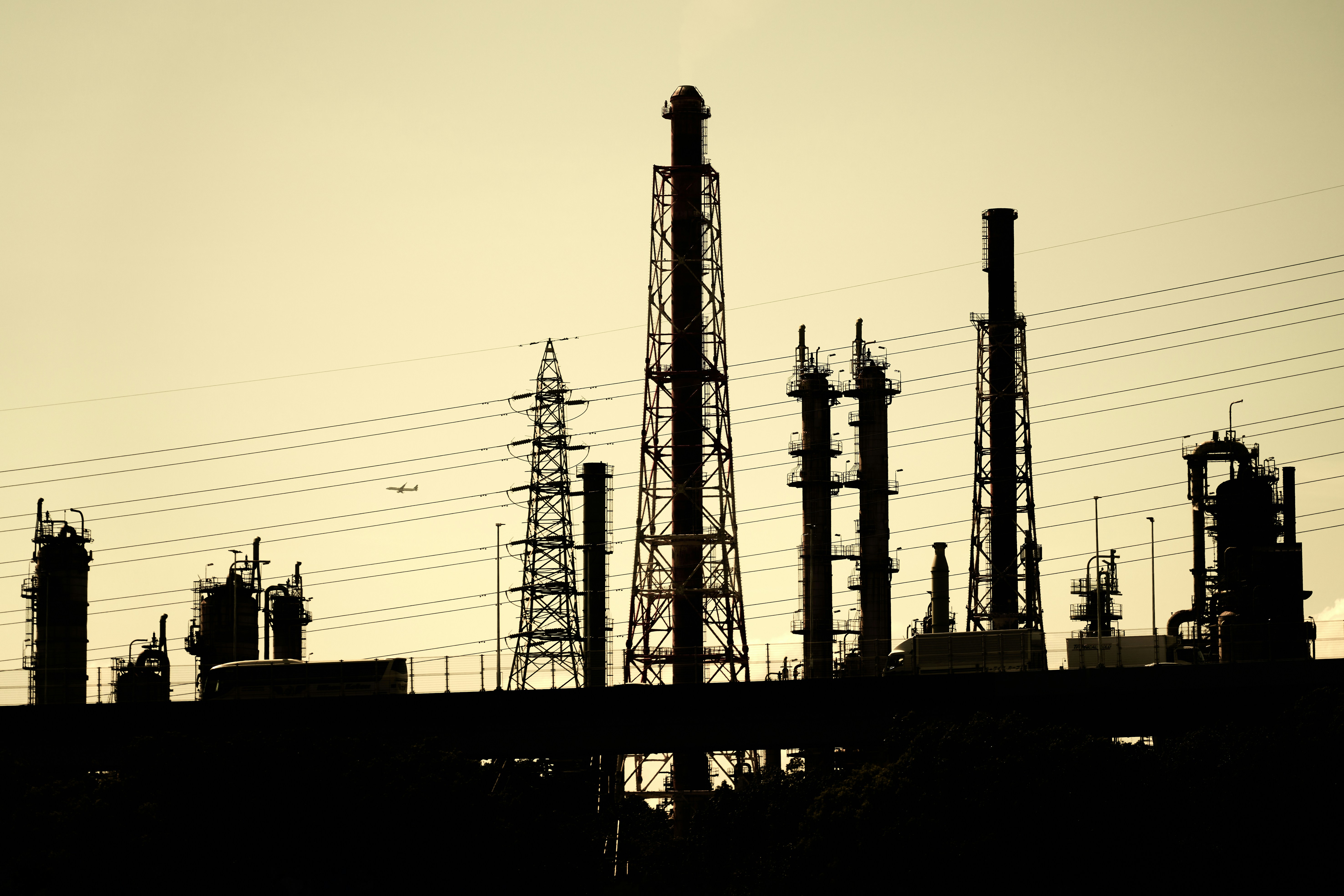 A large factory with lots of pipes and towers