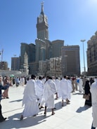 A group of people dressed in white walking through a city