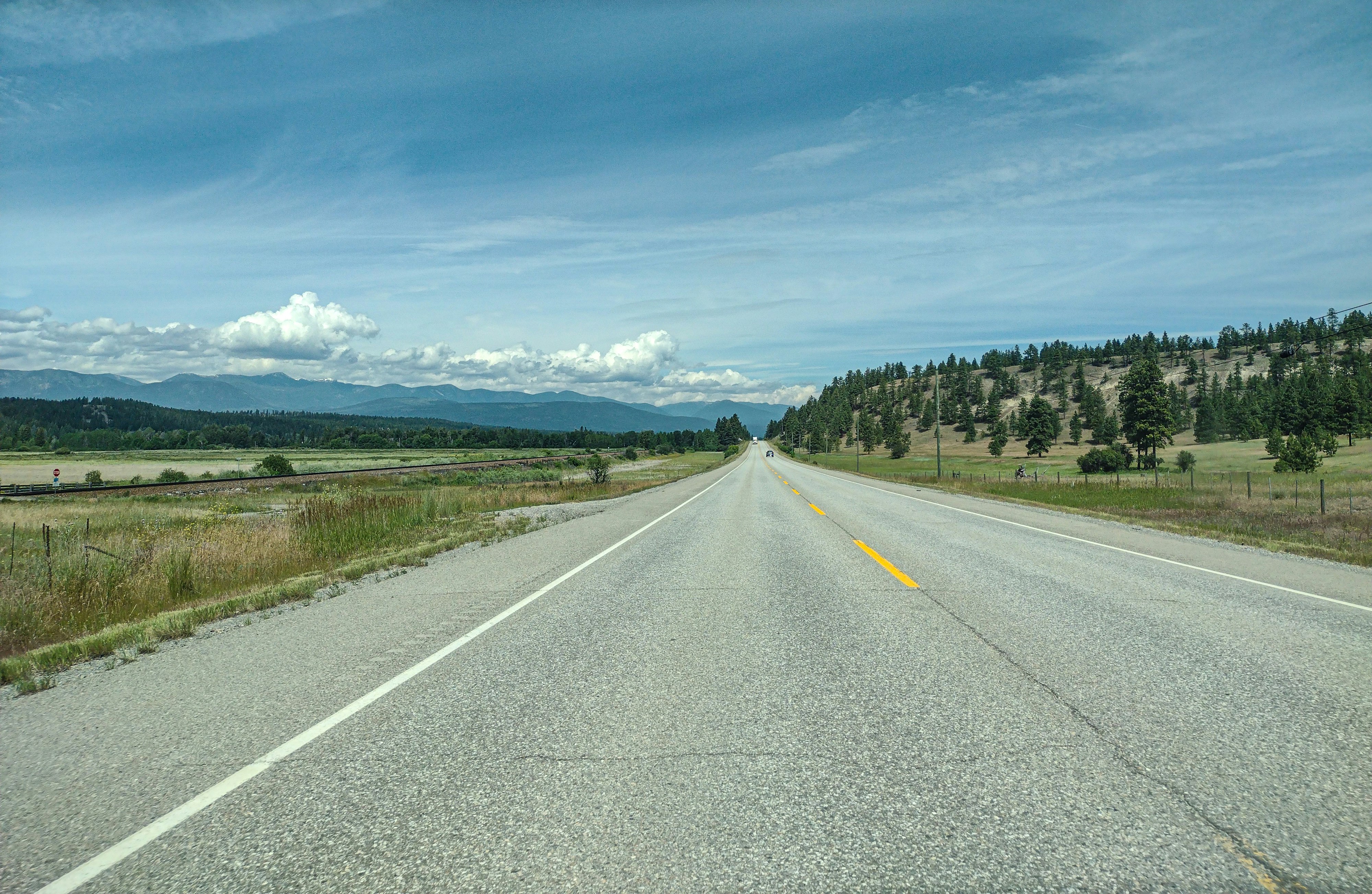 An empty road with a mountain in the background