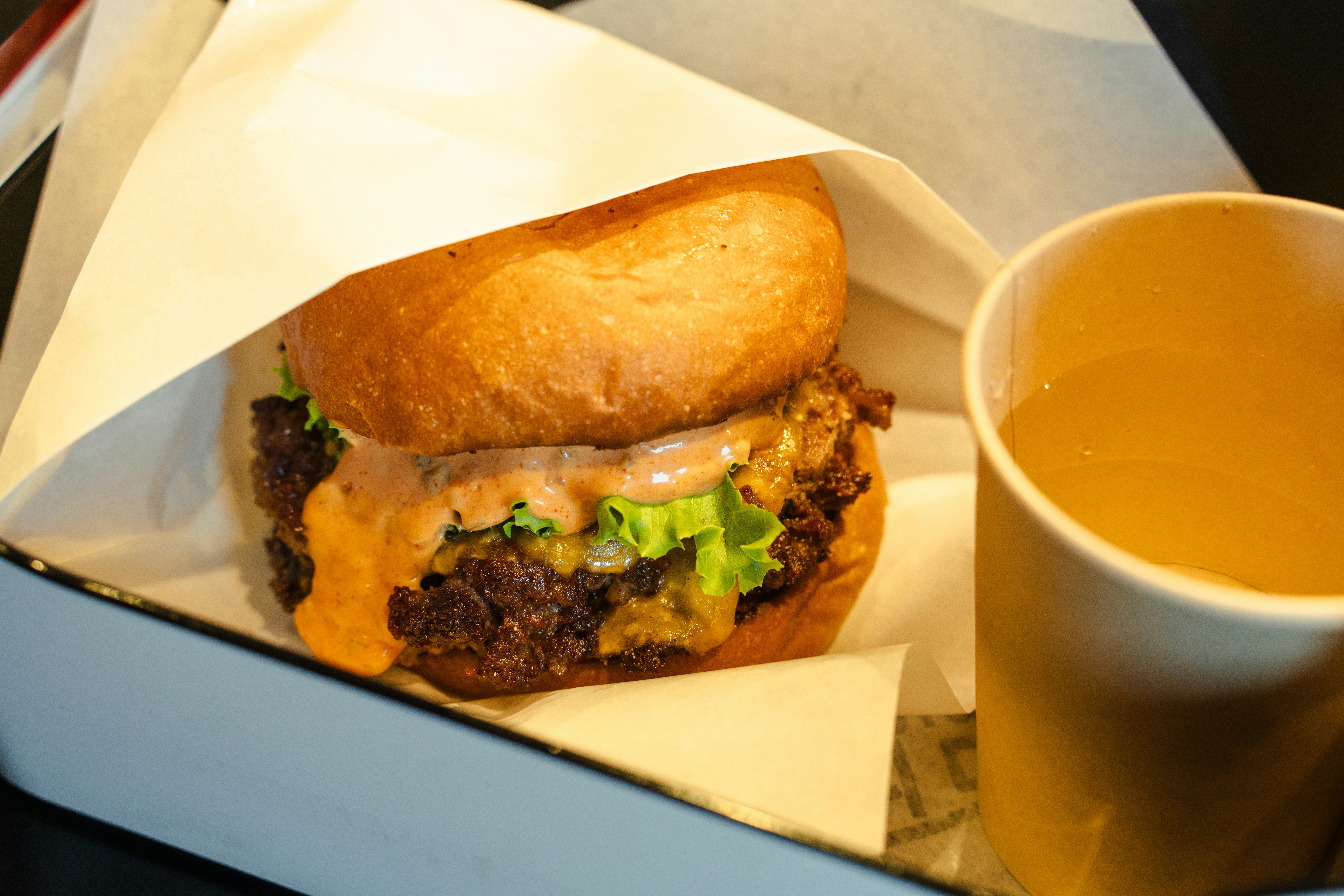 A close up of a sandwich and a cup of tea