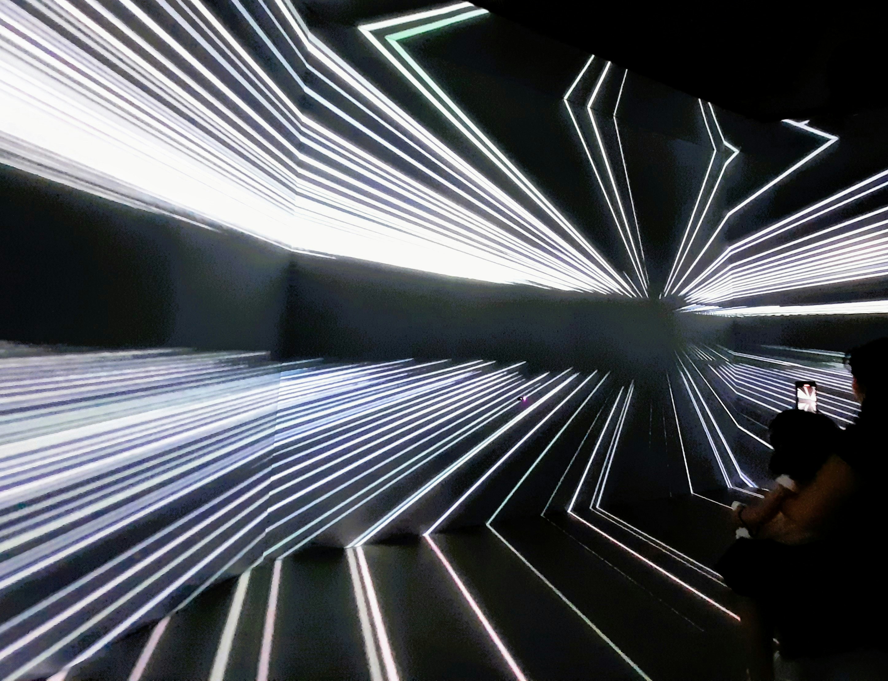 A man sitting on a bench in front of a wall