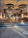 The lobby of a luxury hotel with stairs leading up to the lobby