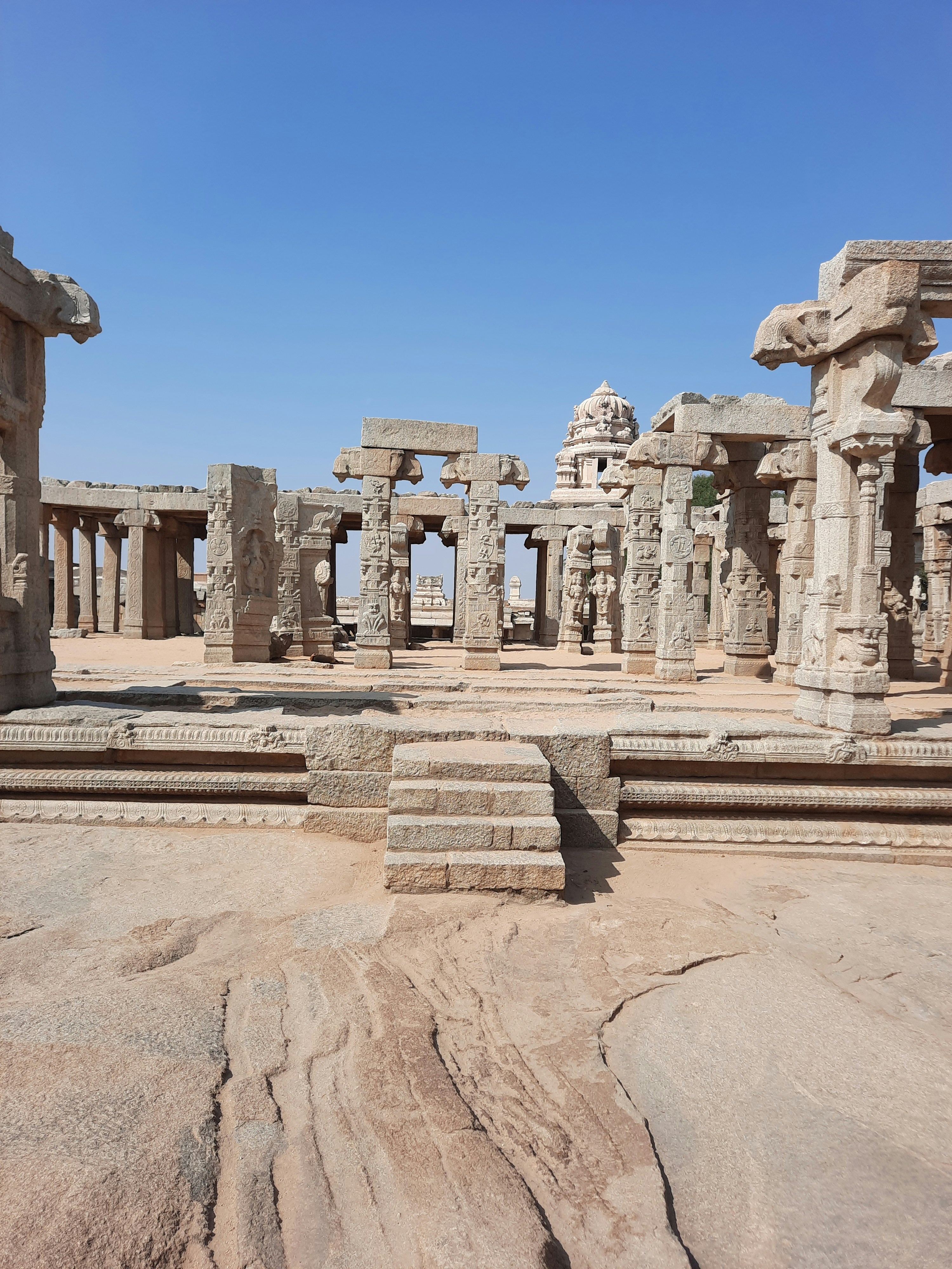 A group of stone structures sitting on top of a dirt field