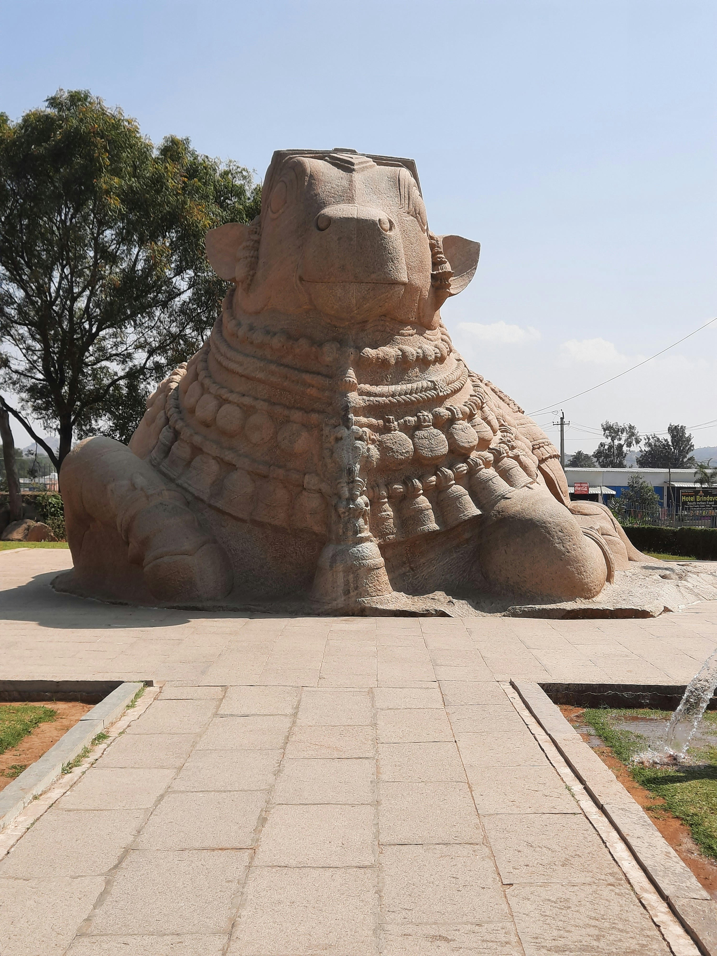 A large sand sculpture of a dog on a walkway
