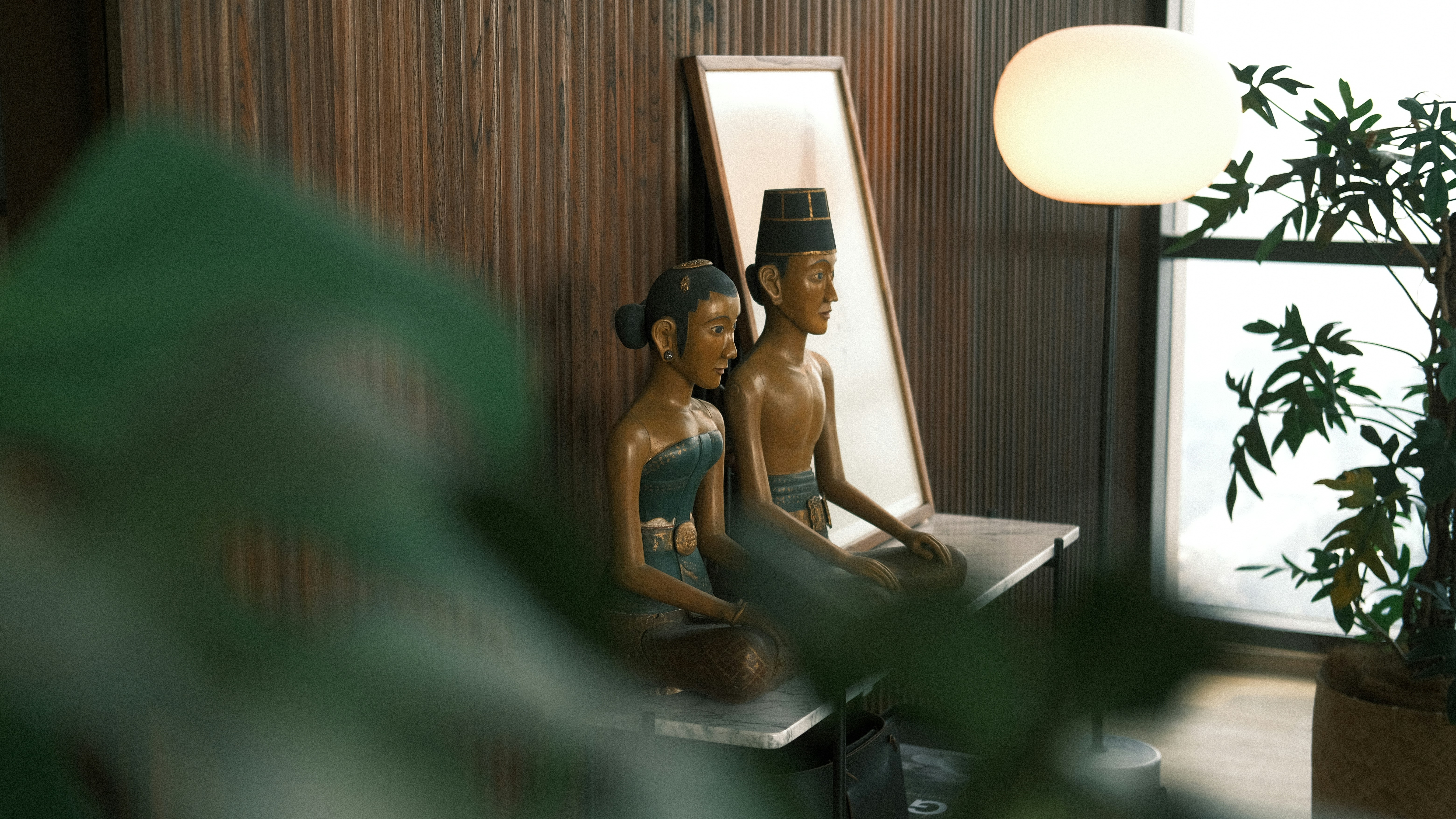 A couple of statues sitting on top of a table