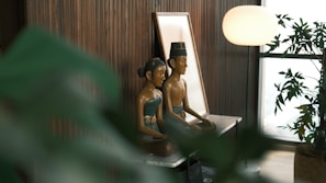 A couple of statues sitting on top of a table