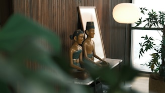 A couple of statues sitting on top of a table