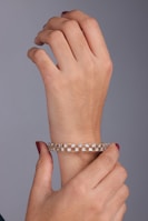 A woman's hand holding onto a bracelet