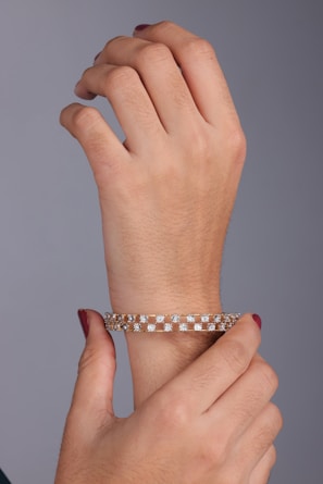 A woman's hand holding onto a bracelet