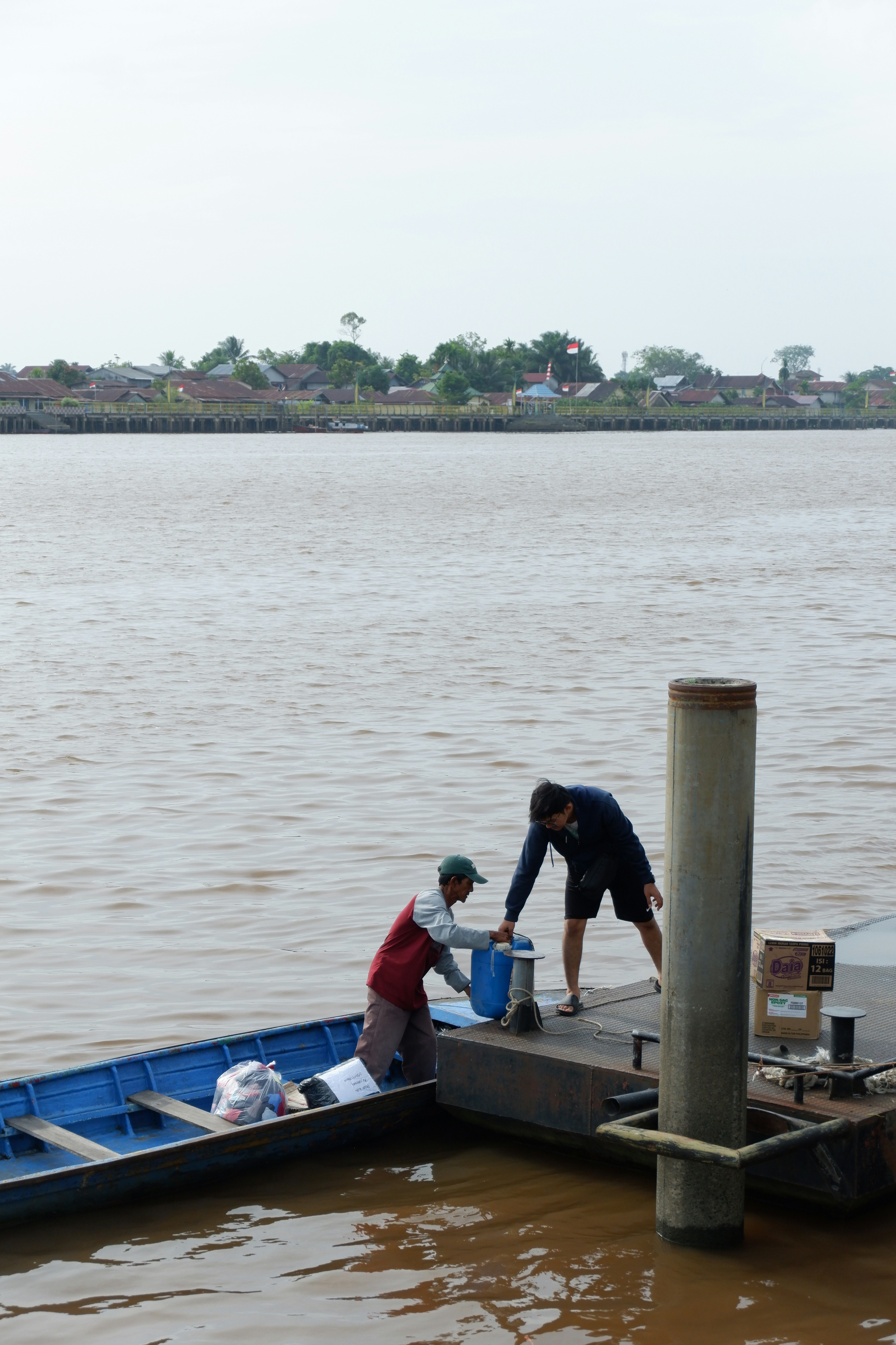 A couple of people that are standing on a boat