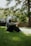 A man sitting in the grass with his feet crossed