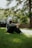 A man sitting in the grass with his feet crossed