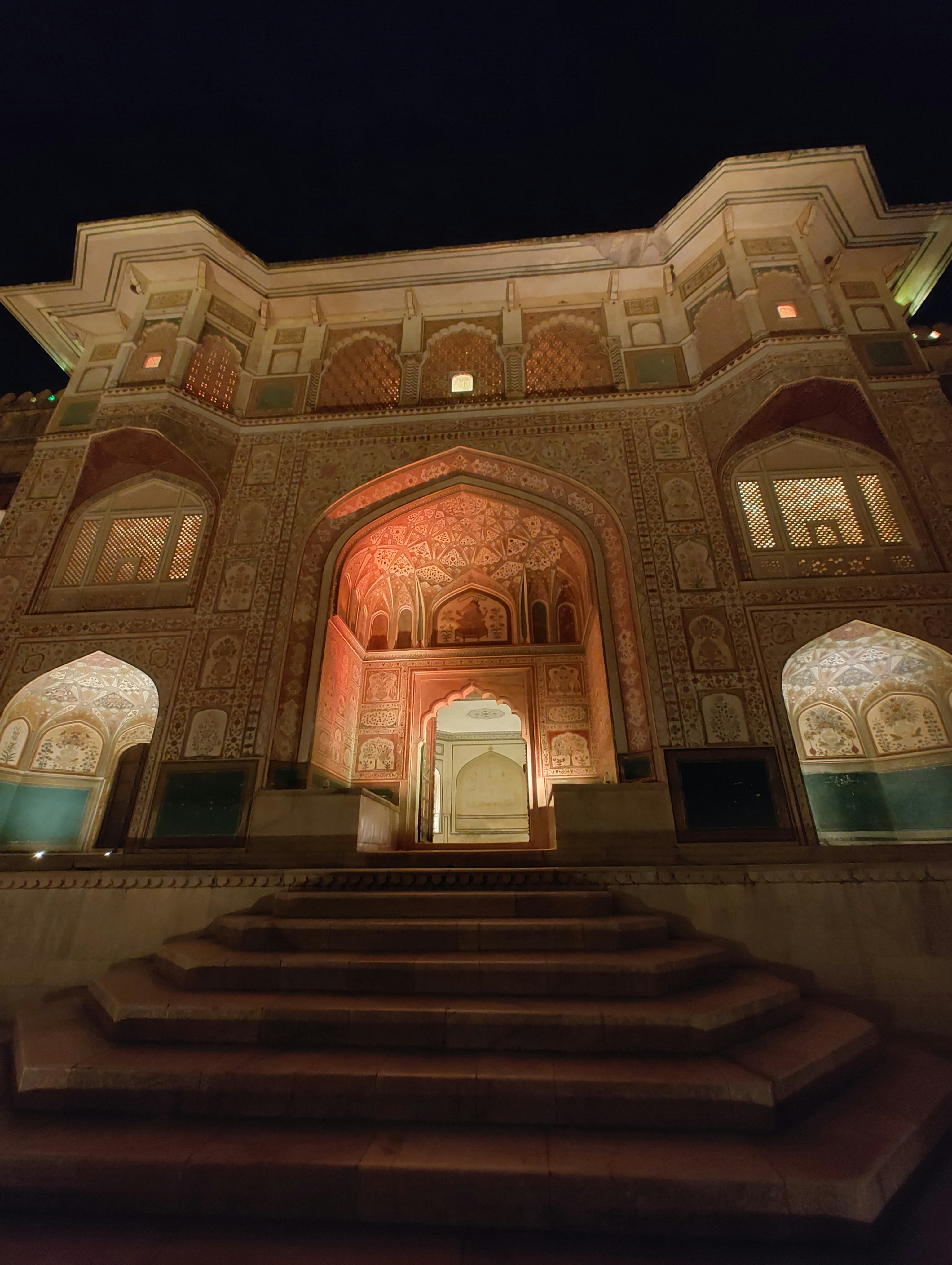 A building lit up at night with steps leading up to it