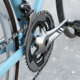 A close up of a bicycle chain and gear