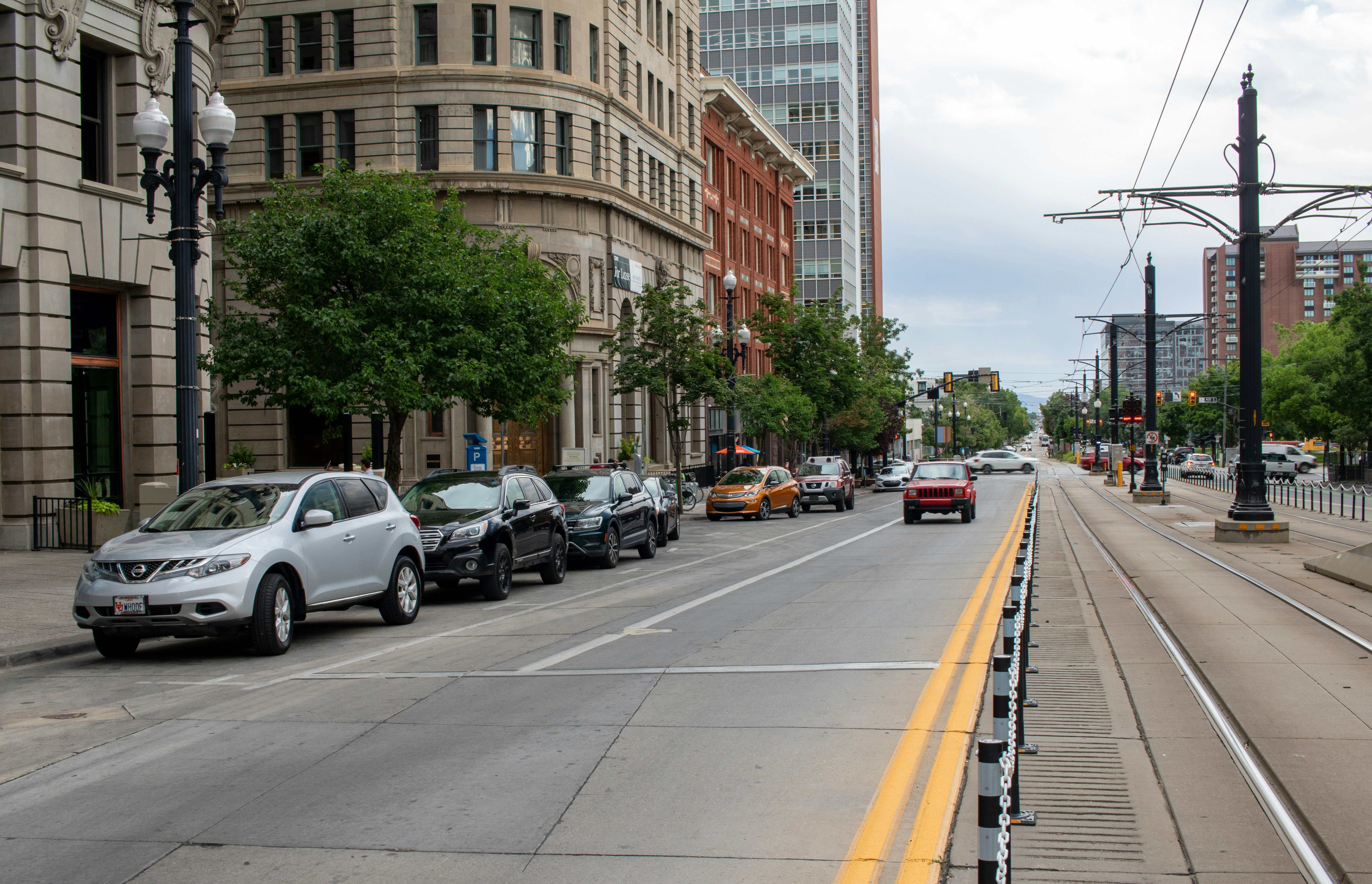 A city street with cars parked on both sides of the street